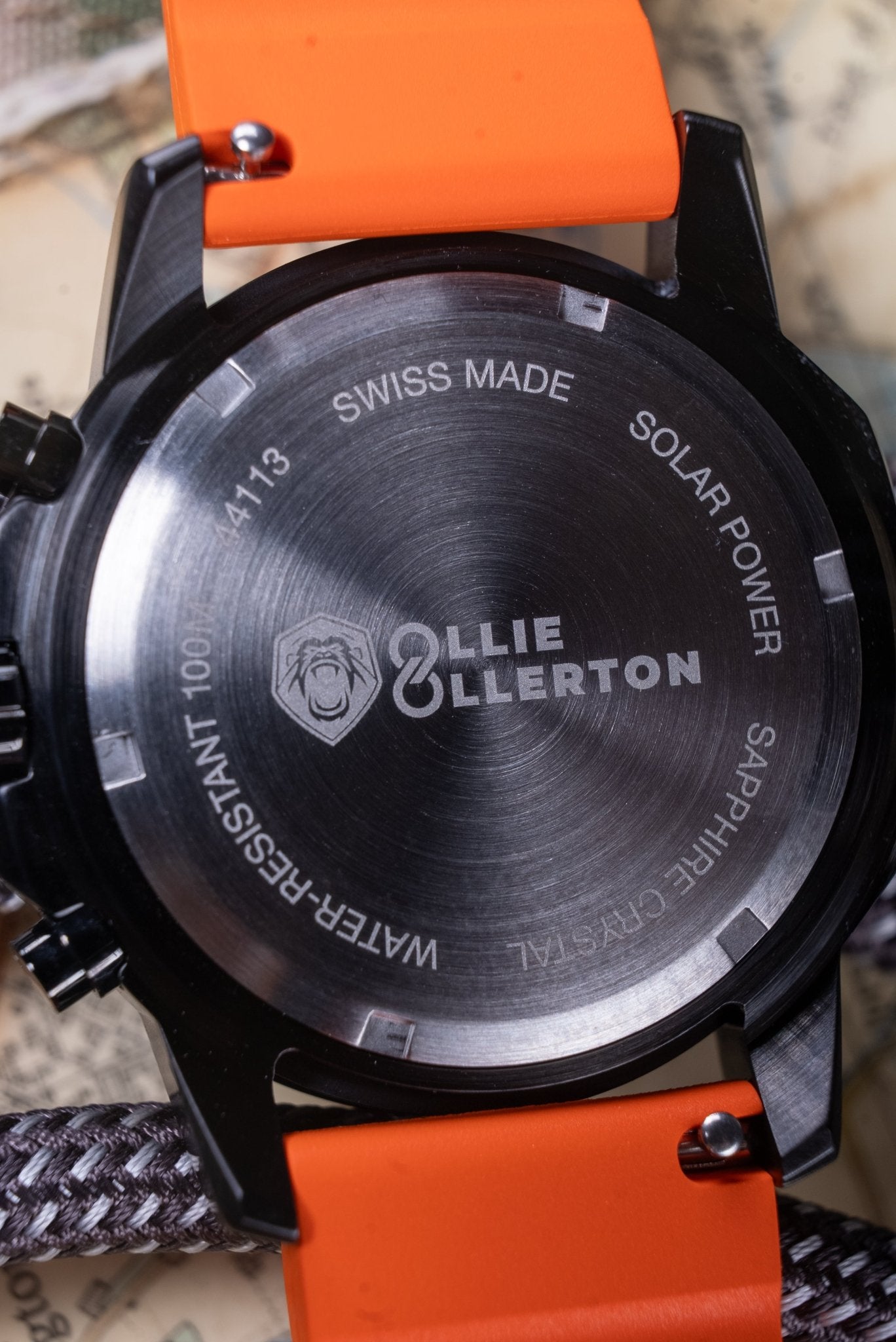 Kennett x Ollie Ollerton Solaforce watch caseback engraving detail showing Swiss made, solar power, 100m water resistance and sapphire crystal markings