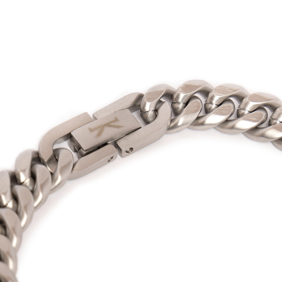 Close-up of the fold-over box clasp on the Kennett Meteorite Curb Chain Bracelet, engraved with the Kennett K logo