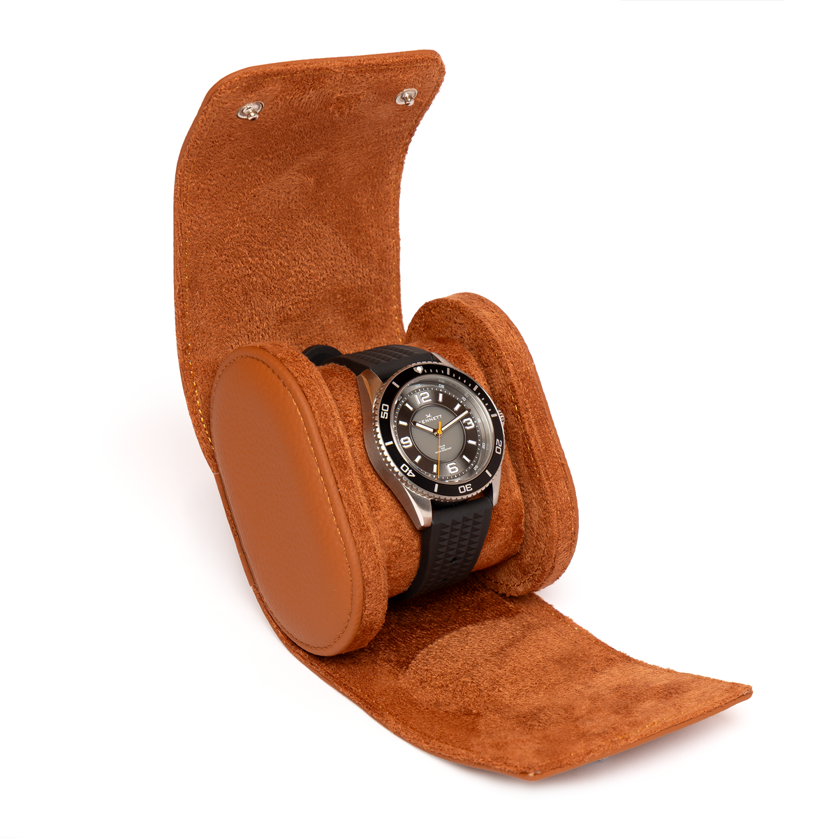 Kennett tan brown leather single watch roll open, holding a dive watch on a black strap around the cushion