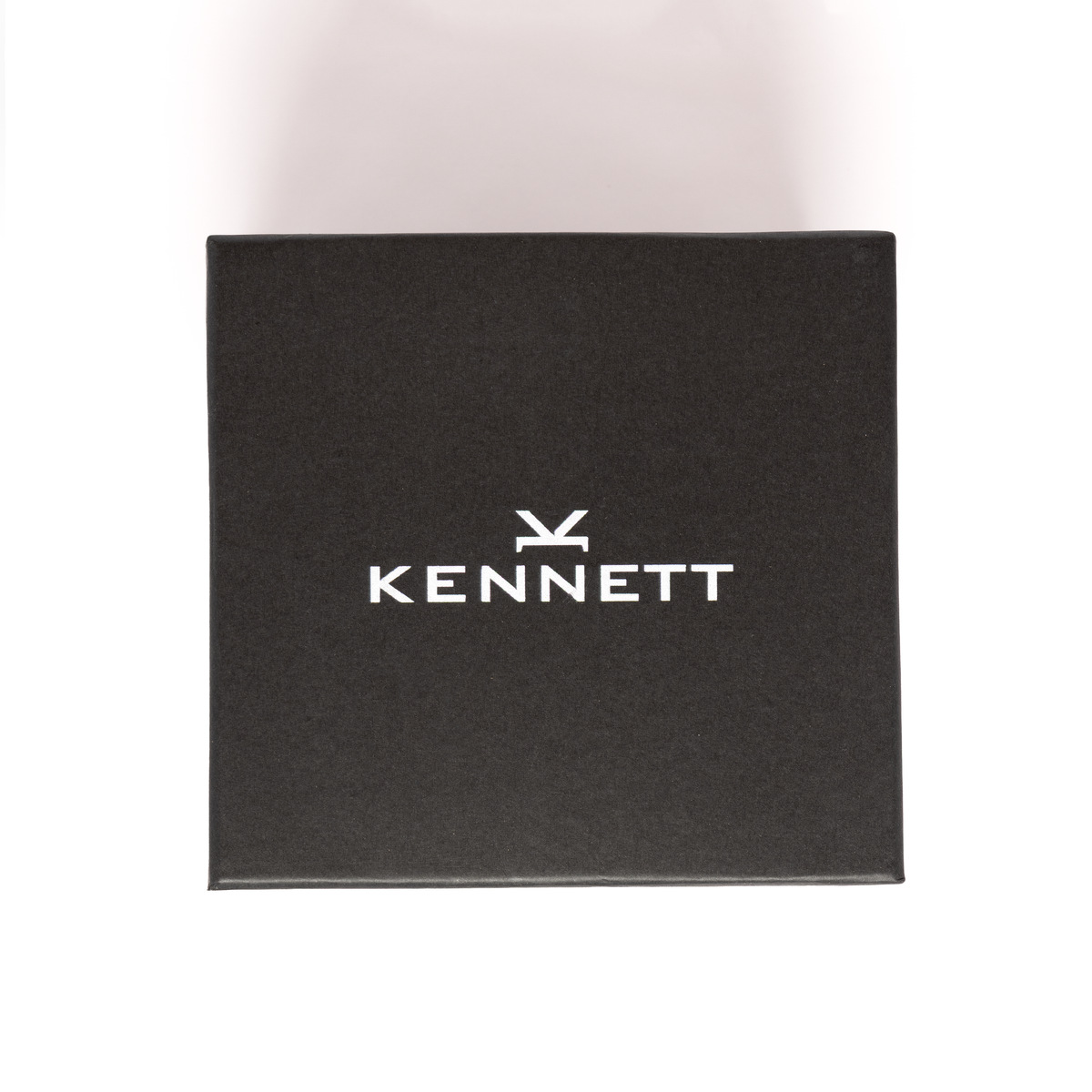 Kennett branded black gift box, closed, with white Kennett logo on the lid