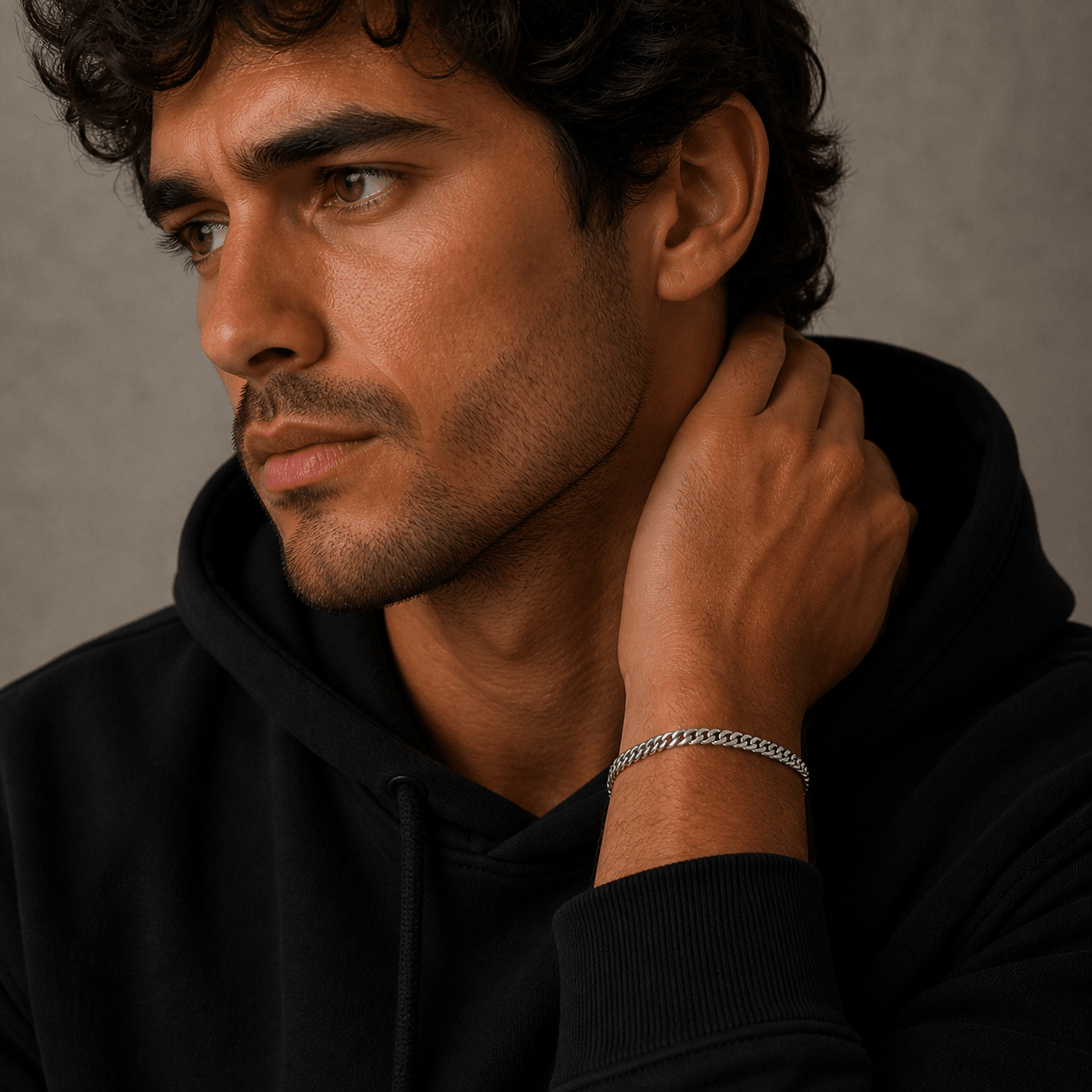 Man wearing a black hoodie with a silver kennett bracelet