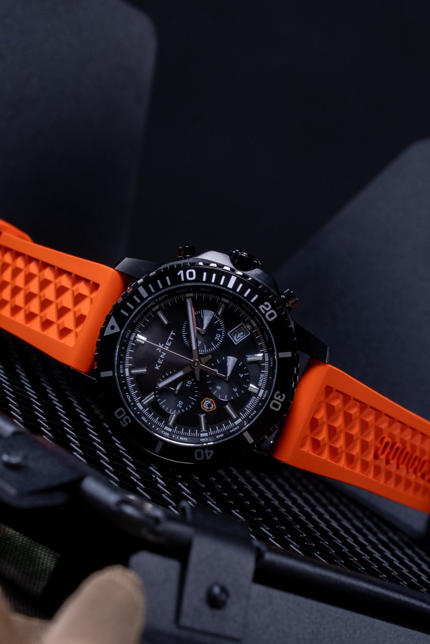 Kennett x Ollie Ollerton Solaforce watch resting on tactical gear, moody lifestyle shot highlighting its rugged military-inspired design