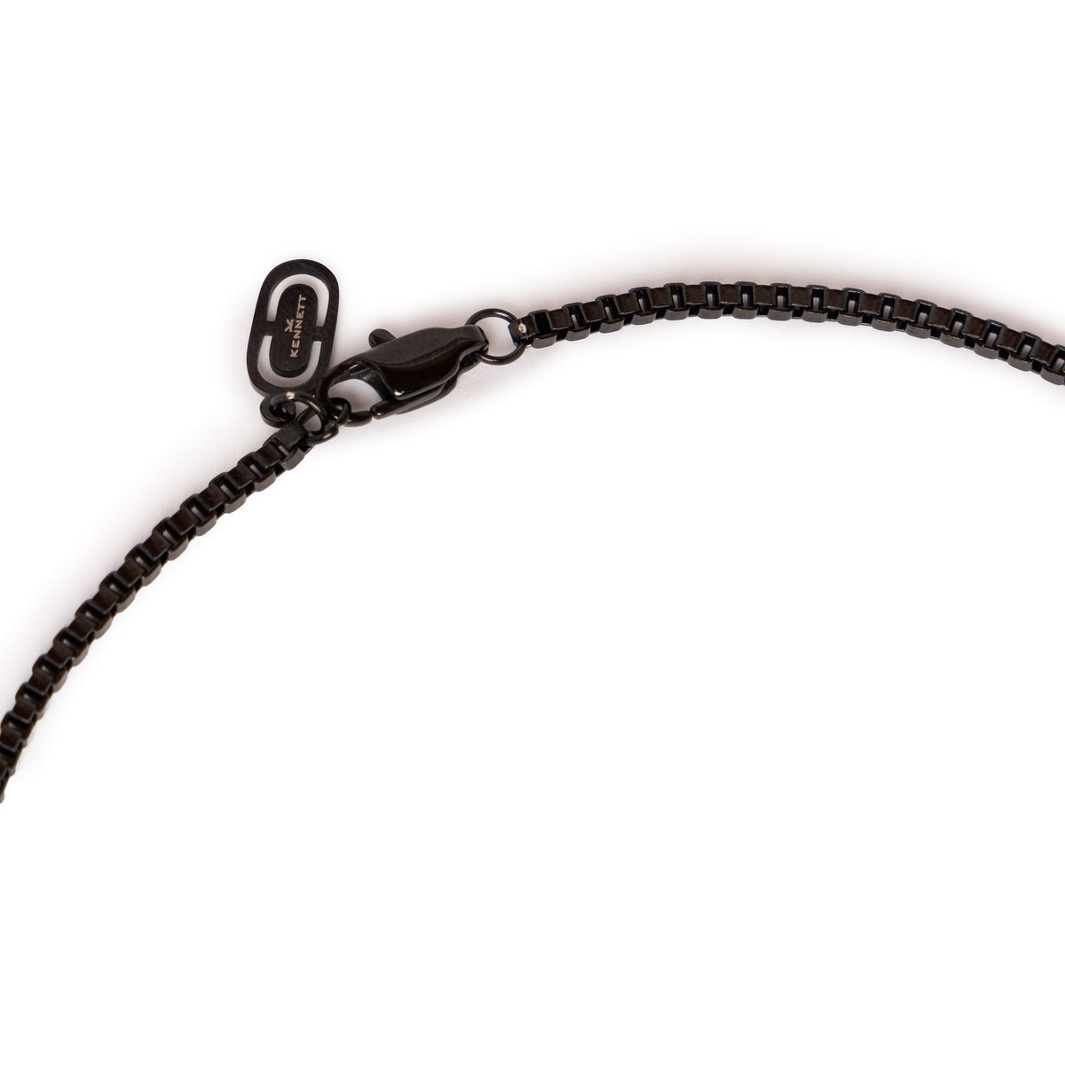 Close-up of the Kennett black box chain necklace's lobster clasp and branded tag